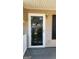 Elegant front door with decorative glass and a stylish exterior light fixture, enhancing curb appeal at 6120 Raleigh Oaks Ct, Lithonia, GA 30058