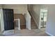 Open entryway with hardwood floors, staircase, and views into the kitchen area, creating a seamless flow at 6120 Raleigh Oaks Ct, Lithonia, GA 30058