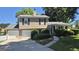 Traditional two-story home with attached garage, landscaped front yard, and welcoming curb appeal on a sunny day at 6120 Raleigh Oaks Ct, Lithonia, GA 30058