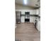 Modern kitchen featuring white cabinets, stainless steel appliances, and sleek countertops with backsplash, an ideal cooking space at 6120 Raleigh Oaks Ct, Lithonia, GA 30058