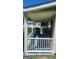 Charming covered porch with white railings, offering a relaxing outdoor space with great natural lighting at 6120 Raleigh Oaks Ct, Lithonia, GA 30058