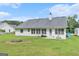 Spacious backyard featuring a well-manicured lawn and home's rear exterior at 1108 The By Way, Mcdonough, GA 30252