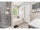 Modern bathroom with a glass-enclosed shower, soaking tub, and stylish patterned tile floor at 1108 The By Way, Mcdonough, GA 30252