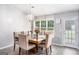 Bright dining room features a chandelier, natural light, and a wooden table with seating for six at 1108 The By Way, Mcdonough, GA 30252