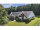 Well-maintained brick and siding home with green lawn and landscaping at 1108 The By Way, Mcdonough, GA 30252
