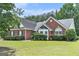 Beautiful brick home with a well-manicured lawn and garden at 1108 The By Way, Mcdonough, GA 30252