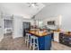 Bright kitchen featuring a large island, white cabinetry, stainless steel appliances, and tile floors at 1108 The By Way, Mcdonough, GA 30252