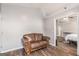 Comfortable sitting area with a brown leather couch and hardwood floors, creating a cozy relaxation space at 1108 The By Way, Mcdonough, GA 30252