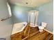 Bright bathroom featuring a corner soaking tub with stone accents, and a glass-enclosed shower at 36 Reese St, Grantville, GA 30220