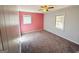 Bright bedroom featuring painted paneling, neutral carpet, and standard windows at 36 Reese St, Grantville, GA 30220