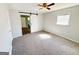 Cozy bedroom featuring neutral walls, barn door to bathroom, and a standard window at 36 Reese St, Grantville, GA 30220
