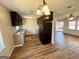 Functional kitchen with stylish black appliances, granite countertops and wood plank flooring at 36 Reese St, Grantville, GA 30220