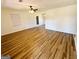 Bright living room featuring wood-look flooring, a ceiling fan, and a glass paneled back door at 36 Reese St, Grantville, GA 30220