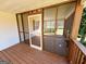 Relaxing screened-in porch features wood flooring and ceiling with an outdoor swing at 36 Reese St, Grantville, GA 30220