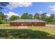 Spacious backyard featuring a brick home with a chain-link fence and a well-maintained lawn at 416 S Carroll Rd, Villa Rica, GA 30180