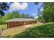 The home has a nice backyard with a brick patio area, a lawn, and a chain-link fence at 416 S Carroll Rd, Villa Rica, GA 30180
