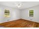 Spacious bedroom with hardwood floors, two windows, and neutral wall color at 416 S Carroll Rd, Villa Rica, GA 30180