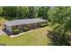 Brick home featuring a lush lawn and mature trees, showcasing its serene setting and classic design at 416 S Carroll Rd, Villa Rica, GA 30180