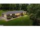 Brick home featuring a lush lawn and mature trees, showcasing its serene setting and classic design at 416 S Carroll Rd, Villa Rica, GA 30180