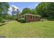 This brick home features classic shutters and landscaping, set on a well-manicured lawn and yard at 416 S Carroll Rd, Villa Rica, GA 30180