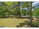 Lush front yard with mature trees, greenery, and a view of the street at 416 S Carroll Rd, Villa Rica, GA 30180