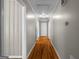 Well-lit hallway with hardwood floors connecting various rooms in the home at 416 S Carroll Rd, Villa Rica, GA 30180