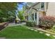 Spacious backyard with a lush lawn, stone pathway, patio furniture, and mature trees for privacy at 750 Highview Ct, Woodstock, GA 30189