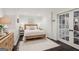 Cozy bedroom with a wooden bed frame, bedside tables and a white rug over the dark hardwood floor at 750 Highview Ct, Woodstock, GA 30189