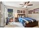 Bedroom with a wooden bed frame, ceiling fan, baseball themed decor, and natural light at 750 Highview Ct, Woodstock, GA 30189