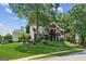 Brick home with lush landscaping, mature trees, and a well-maintained lawn in a suburban setting at 750 Highview Ct, Woodstock, GA 30189