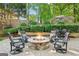 Outdoor stone fire pit with comfortable seating, creating a cozy gathering space in the landscaped backyard at 750 Highview Ct, Woodstock, GA 30189