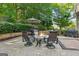Backyard stone fire pit surrounded by chairs and patio furniture, ideal for outdoor entertaining at 750 Highview Ct, Woodstock, GA 30189