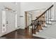 Bright foyer featuring hardwood floors, a staircase, and a view into the dining room at 750 Highview Ct, Woodstock, GA 30189