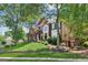 Attractive brick home with a well-kept lawn, featuring an inviting front porch and manicured shrubs at 750 Highview Ct, Woodstock, GA 30189