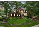 Stately brick home featuring manicured landscaping, shuttered windows, and a welcoming front porch at 750 Highview Ct, Woodstock, GA 30189
