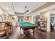 Game room with a pool table, hardwood floors, seating, and stylish lighting at 750 Highview Ct, Woodstock, GA 30189