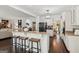 Spacious kitchen with a central island, seating, granite countertops, and seamless access to a cozy living area at 750 Highview Ct, Woodstock, GA 30189
