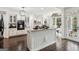 Open kitchen features white cabinets, granite countertops, a center island, and seamless access to other living spaces at 750 Highview Ct, Woodstock, GA 30189