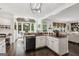Bright kitchen with granite countertops, black appliances, a view to a sunroom and access to the living room at 750 Highview Ct, Woodstock, GA 30189