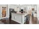 Stylish kitchen with granite counters, white cabinets, modern appliances, and a convenient center island at 750 Highview Ct, Woodstock, GA 30189
