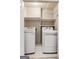 Convenient laundry room with a side-by-side washer and dryer and built-in shelving at 750 Highview Ct, Woodstock, GA 30189