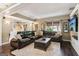 Spacious living room featuring hardwood floors, a large leather sectional sofa, and natural light at 750 Highview Ct, Woodstock, GA 30189