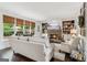 Cozy living room featuring a stone fireplace, built-in shelving, and large windows with backyard views at 750 Highview Ct, Woodstock, GA 30189