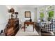 Stylish home office with a wooden desk, patterned chairs, and ample natural light at 750 Highview Ct, Woodstock, GA 30189
