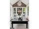 Sunroom with vaulted ceiling, many windows, natural light, and a stylish sitting area with arm chairs at 750 Highview Ct, Woodstock, GA 30189