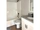 Bathroom features a shower-tub combo, toilet, vanity with sink, and granite countertop at 1705 Lake Dow Rd, Mcdonough, GA 30252
