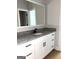 Bathroom showcasing a vanity with white cabinets, a granite countertop, sink, and mirror at 1705 Lake Dow Rd, Mcdonough, GA 30252