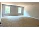 Bright bedroom with two windows providing ample natural light, and neutral colored carpet at 1705 Lake Dow Rd, Mcdonough, GA 30252