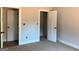 This carpeted bedroom features a closet with wire shelving, and a doorway leading to another room at 1705 Lake Dow Rd, Mcdonough, GA 30252
