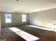 An open and bright bedroom space featuring two windows and neutral carpeting at 1705 Lake Dow Rd, Mcdonough, GA 30252